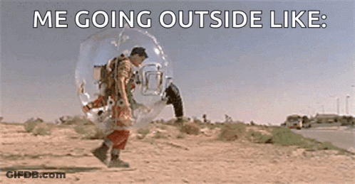 A Man Is Walking In A Bubble On The Side Of A Road . GIF