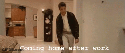A Man Is Walking In A Hallway With The Words Coming Home After Work Written On The Wall Behind Him . GIF