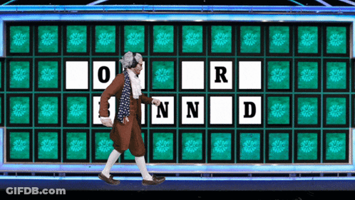 A Man Is Walking In Front Of A Wheel Of Fortune With The Letters O R N And D GIF