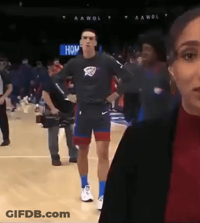 A Man Is Walking On A Basketball Court While A Woman Looks On GIF