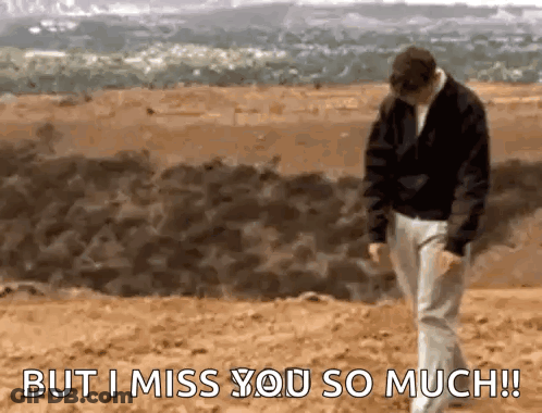 A Man Is Walking On A Beach With The Words `` But I Miss You So Much '' Written On The Bottom . GIF