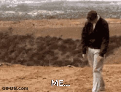 A Man Is Walking On A Dirt Road And Says Me GIF