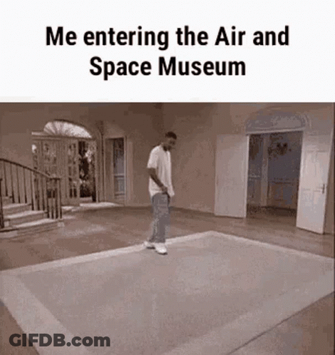 A Man Is Walking On A Rug In A Room With The Words `` Me Entering The Air And Space Museum '' Written On It . GIF