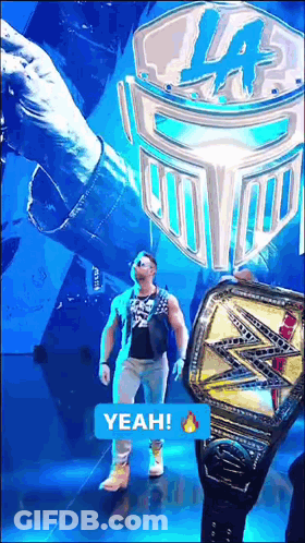 A Man Is Walking On A Stage With A Yeah Sticker On The Bottom GIF