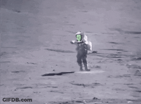 A Man Is Walking On The Moon With A Green Screen On His Helmet . GIF