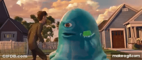 A Man Is Walking Past A Blue Monster With A Green Toothbrush . GIF