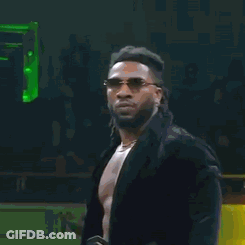 A Man Is Walking Through A Tunnel With Christmas Trees And A Ruler Sign GIF
