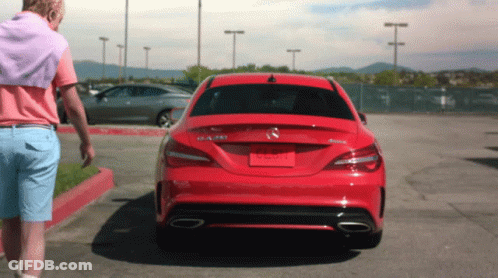 A Man Is Walking Towards A Red Mercedes Benz Car GIF
