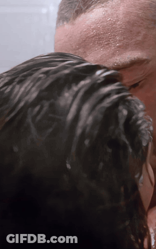 A Man Is Washing A Woman 'S Hair In The Shower GIF
