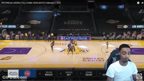 A Man Is Watching A Basketball Game Between The Pistons And Los Angeles Lakers GIF