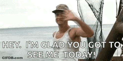 A Man Is Waving At The Camera While Standing On A Boat . GIF