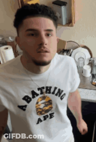 A Man Is Wearing A Bathing Ape Shirt GIF