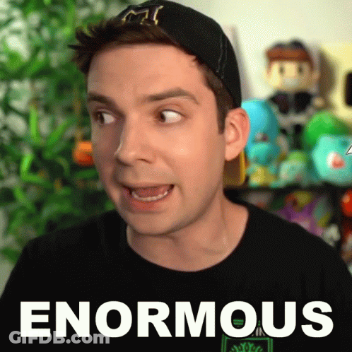 A Man Is Wearing A Black Shirt That Says Enormous On It GIF