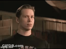 A Man Is Wearing A Black Shirt That Says G.r.k. On It GIF
