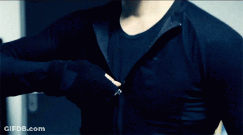 A Man Is Wearing A Black Shirt With A Zipper On The Front GIF