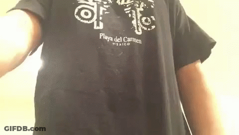 A Man Is Wearing A Black T-Shirt That Says Playa Del Carmen Mexico On It . GIF