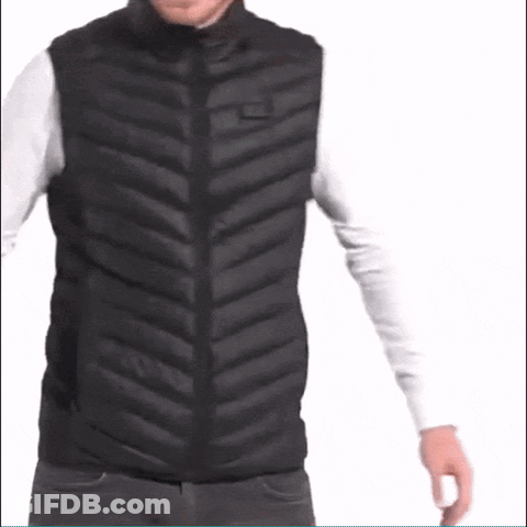 A Man Is Wearing A Black Vest And A White Shirt . GIF