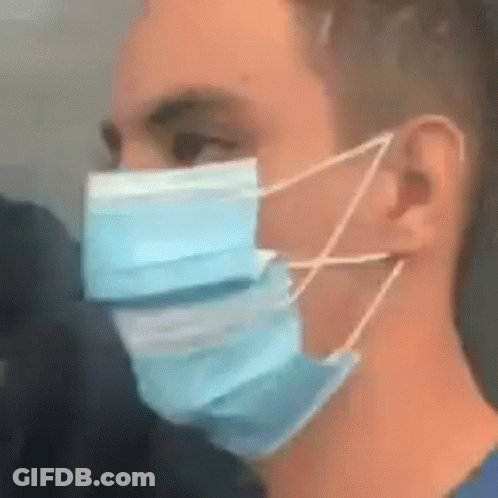 A Man Is Wearing A Blue Face Mask With A String Around His Ear . GIF