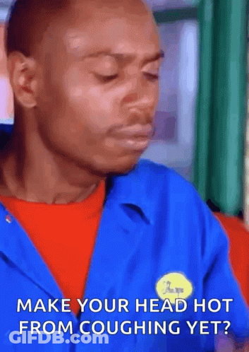 A Man Is Wearing A Blue Jacket And A Yellow Badge That Says Make Your Head Hot From Coughing Yet . GIF