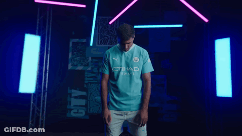 A Man Is Wearing A Blue Shirt That Says Etihad Airways GIF