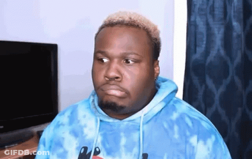 A Man Is Wearing A Blue Tie Dye Hoodie And Making A Funny Face . GIF
