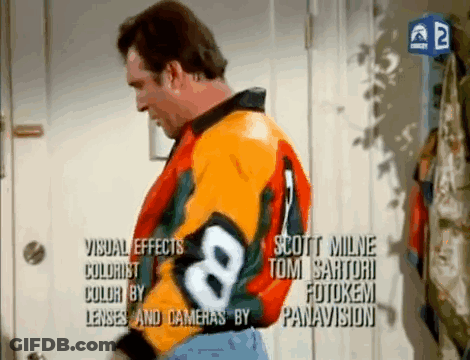 A Man Is Wearing A Colorful Jacket With The Number 8 On It GIF