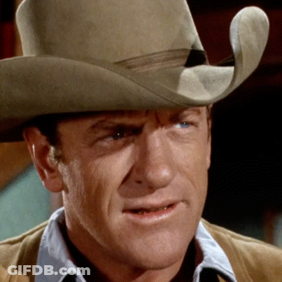 A Man Is Wearing A Cowboy Hat And A Brown Jacket GIF