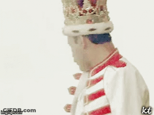 A Man Is Wearing A Crown And Holding A Drum In His Hand . GIF