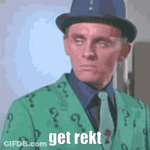 A Man Is Wearing A Green Suit With Question Marks On It GIF