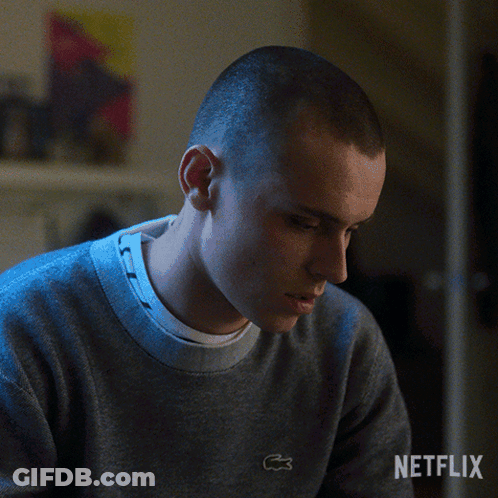 A Man Is Wearing A Grey Sweater With A Lacoste Logo On The Front GIF