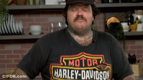 A Man Is Wearing A Harley Davidson T-Shirt And A Hat GIF