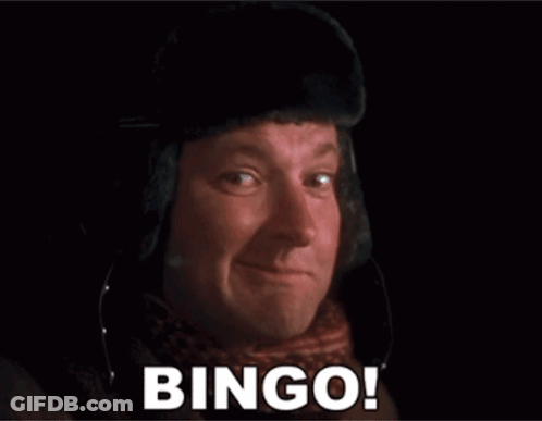 A Man Is Wearing A Hat And Scarf And Says Bingo GIF