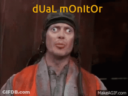 A Man Is Wearing A Helmet And An Orange Vest And The Words Dual Monitor Are Above Him GIF
