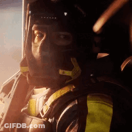 A Man Is Wearing A Helmet And Headphones While Sitting In A Plane . GIF