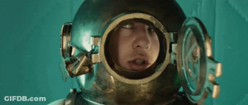 A Man Is Wearing A Helmet With A Hole In It For His Face . GIF