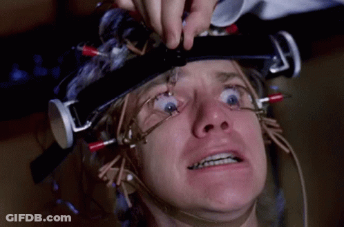 A Man Is Wearing A Helmet With Wires Coming Out Of It GIF