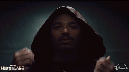A Man Is Wearing A Hooded Jacket With The Words Ironheart On The Bottom GIF