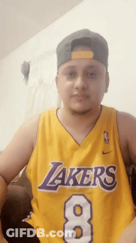 A Man Is Wearing A Lakers Jersey With The Number 8 On It GIF