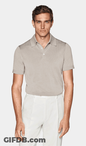 A Man Is Wearing A Light Blue Polo Shirt And White Pants GIF