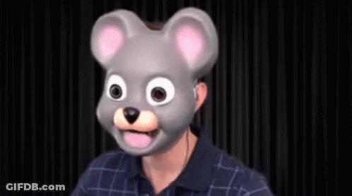 A Man Is Wearing A Mouse Mask With His Tongue Out . GIF