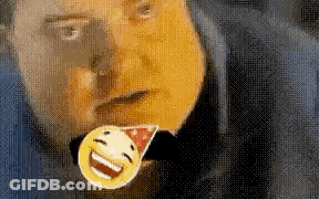 A Man Is Wearing A Party Hat And Holding A Smiley Face Pin In His Mouth . GIF