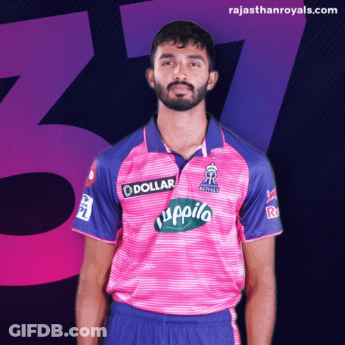 A Man Is Wearing A Pink And Blue Shirt With A Dollar Logo On It GIF