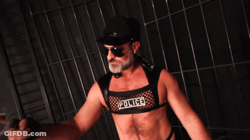 A Man Is Wearing A Police Vest And Sunglasses GIF
