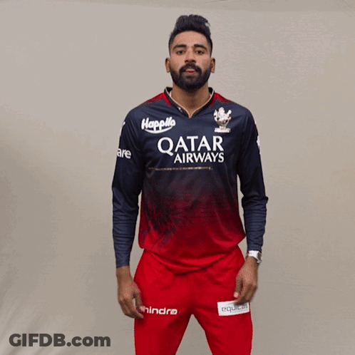 A Man Is Wearing A Qatar Airways Shirt And Red Pants GIF