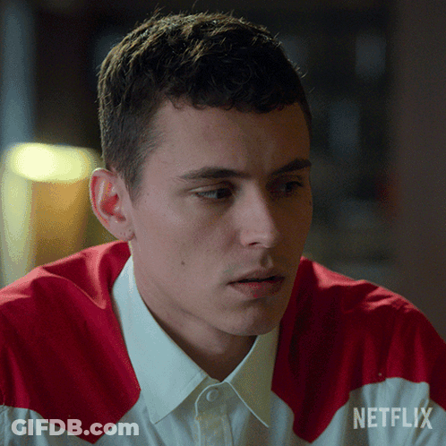 A Man Is Wearing A Red And White Shirt With Netflix Written On The Sleeve GIF