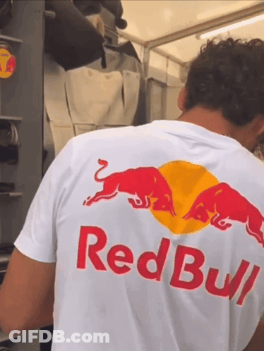 A Man Is Wearing A Red Bull Shirt GIF