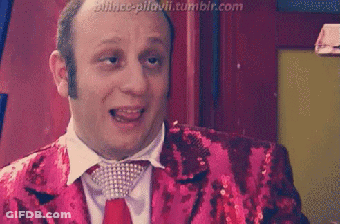 A Man Is Wearing A Red Sequined Jacket And Tie With A Tumblr.com Watermark GIF