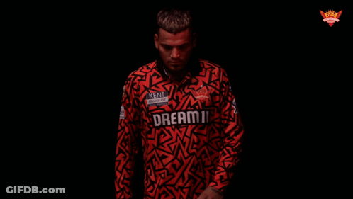 A Man Is Wearing A Red Shirt That Says Kent On It GIF