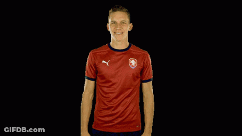 A Man Is Wearing A Red Shirt With A Puma Logo On It GIF