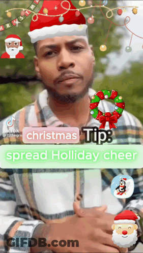 A Man Is Wearing A Santa Hat And A Christmas Wreath GIF